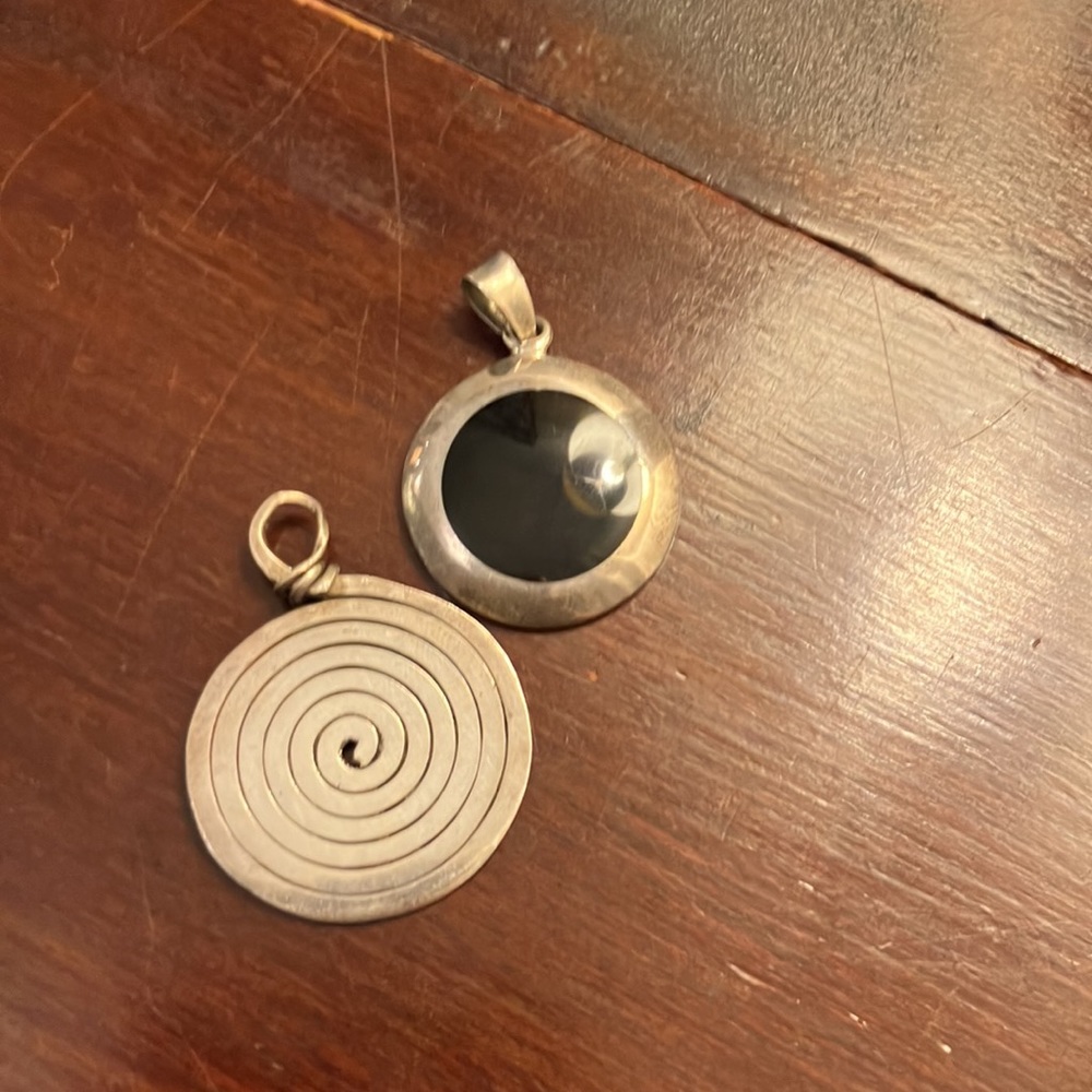 Bundle of two sterling silver pendants one has onyx